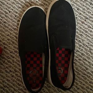Black slip on shoes with red and black checkered inside